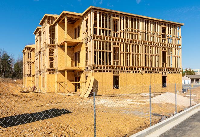 a close-up of temporary chain link fences enclosing a construction site, signaling progress in the project's development in Reidsville